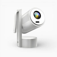 Portable projector with circular front lens and side handle, white housing